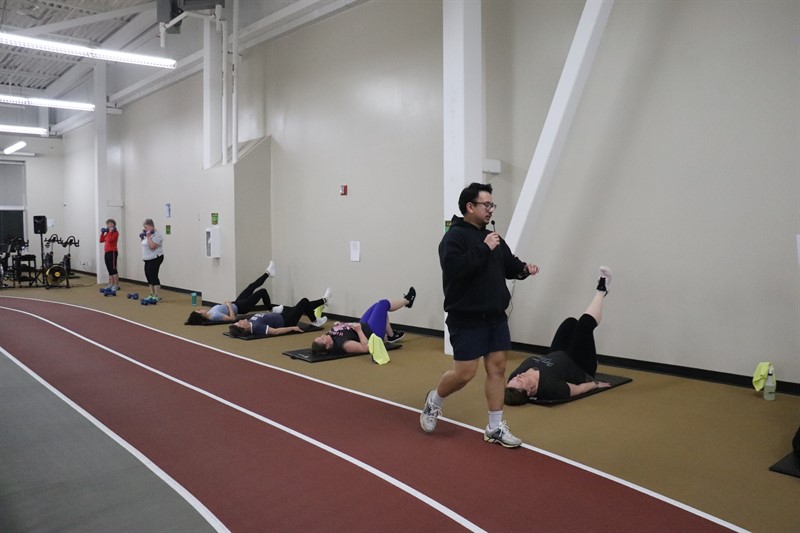 Registration-Fitness Instructor leads fitness class